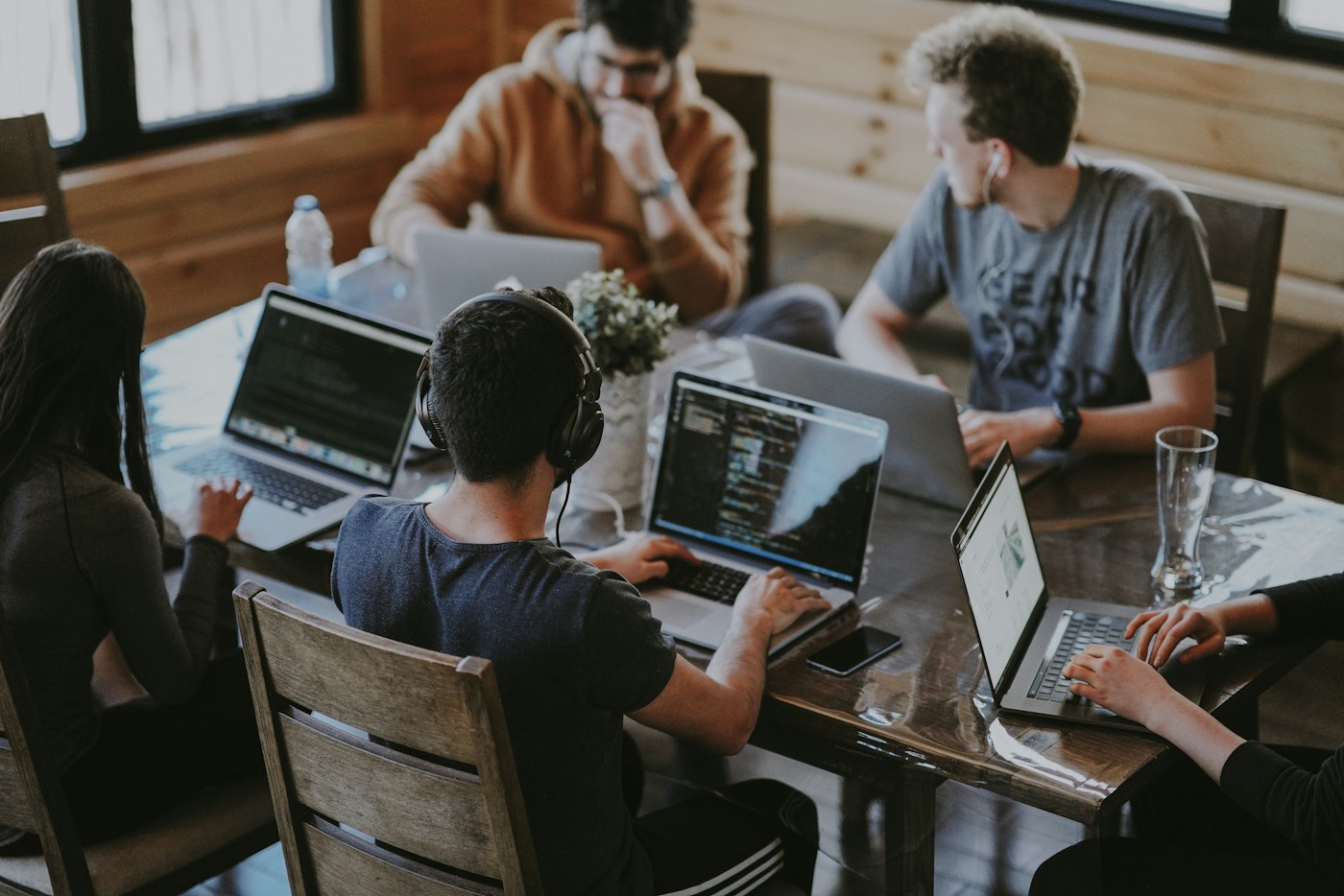 Professionals collaborating around a table; illustrative stock photograph